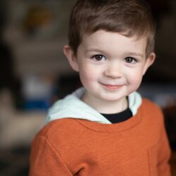 a little boy that is smiling for the camera